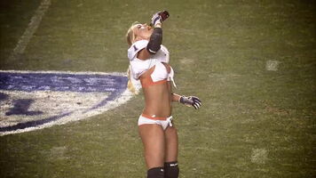 Guzzling her delicious beer on the football field