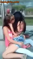 Latinas make out while waiting for the bus