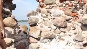 Naked And Cautious At The Castle Ruins While Tourists Are Behind The Wall